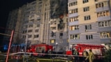 Firefighters work at the site of an apartment building damaged during a Russian drone strike in the town of Hlevakha, Kyiv region, Ukraine, on January 24.