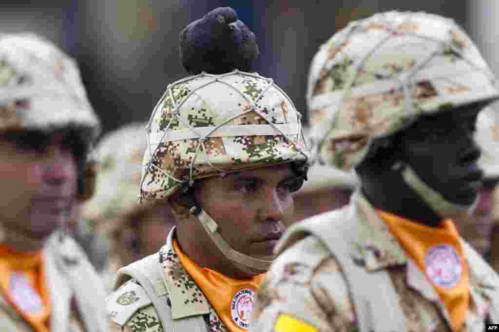 A pigeon perches on the helmet of a Colombian infantry soldier who will be deployed as part of the Multinational Force and Observers (MFO) peacekeeping force overseeing the terms of the peace treaty between Egypt and Israel in the Sinai Peninsula during a ceremony on Bolivar Square in Bogota. (AFP/Eitan Abramovich)