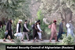 Newly freed Taliban prisoners walk out of Pul-e-Charkhi prison in Kabul on August 13.