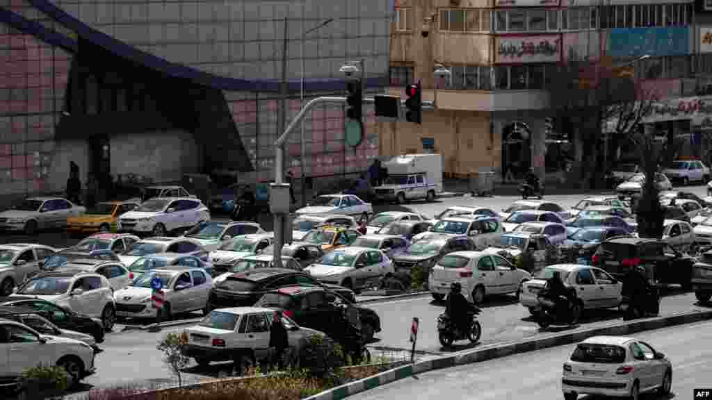 Motorists make their way along a street in central Tehran on February 28. 
