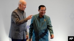 U.S. President Joe Biden (left) is greeted by Cambodia's Prime Minister Hun Sen before the ASEAN gala dinner on November 12 in Phnom Penh, Cambodia.
