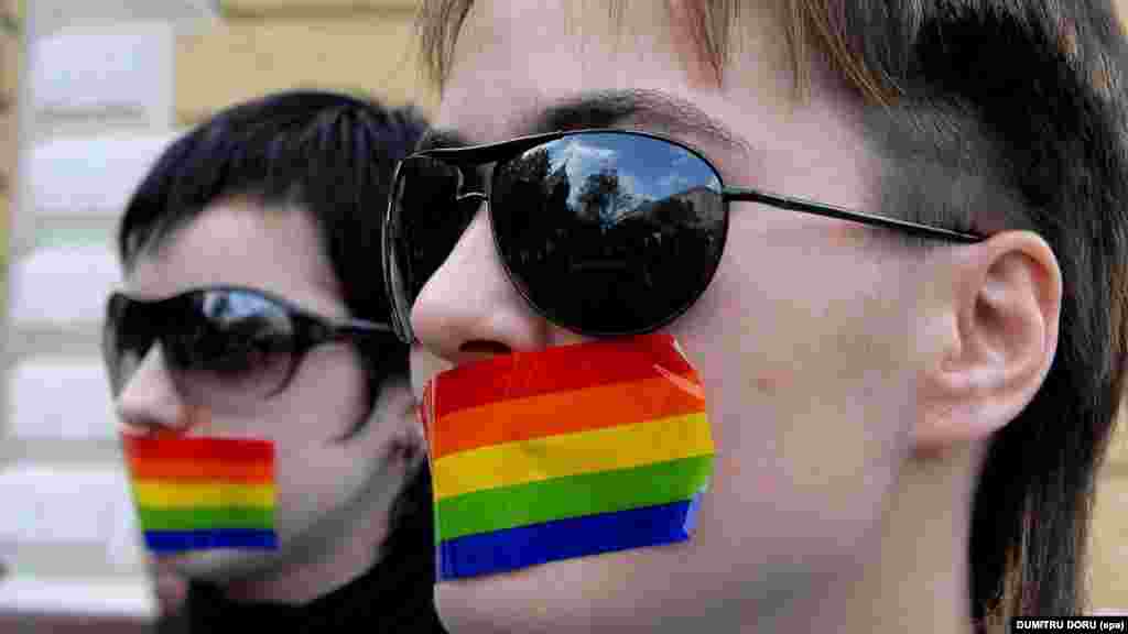 Two Moldovan lesbians cover their mouths during a silent protest in the Moldovan capital, Chisinau, on April 27, 2007, after the authorities banned a public event by an LGBT group.