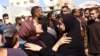 Palestinians react outside the al-Aqsa Martyrs hospital after an Israeli strike hit a school housing displaced people in Deir al-Balah in the central Gaza Strip on October 10.