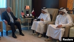 U.S. Secretary of State Rex Tillerson (left) meets with Qatari Foreign Minister Sheikh Muhammad bin Abdulrahman al-Thani (center) in Doha on July 11.