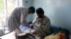 An Afghan lecturer of Kandahar University receives medical treatment at a hospital after he was release by unknown gunmen, in Ghazni, June 10, 2014