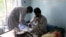 An Afghan lecturer of Kandahar University receives medical treatment at a hospital after he was release by unknown gunmen, in Ghazni, June 10, 2014