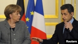 French President Nicolas Sarkozy (right) and German Chancellor Angela Merkel at the Elysee Palace in Paris on February 6