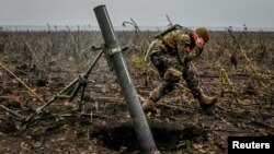 A Ukrainian soldier fires a mortar on the front line in the Zaporizhzhya region on November 16.