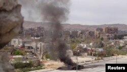 A tank belonging to government forces is set on fire during clashes between government forces and the Free Syrian Army, on the main southern highway near Damascus, on March 19.
