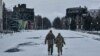 Ukrainian soldiers walk along a street lined with damaged buildings in Bakhmut, Donetsk region, on February 12.