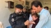 Police in Khyber Pakhtunkhwa Province's Bajaur district take part in vaccinating children again polio in September. 