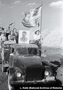 Workers on a collective farm near Jogeva display a portrait of Stalin in 1951.