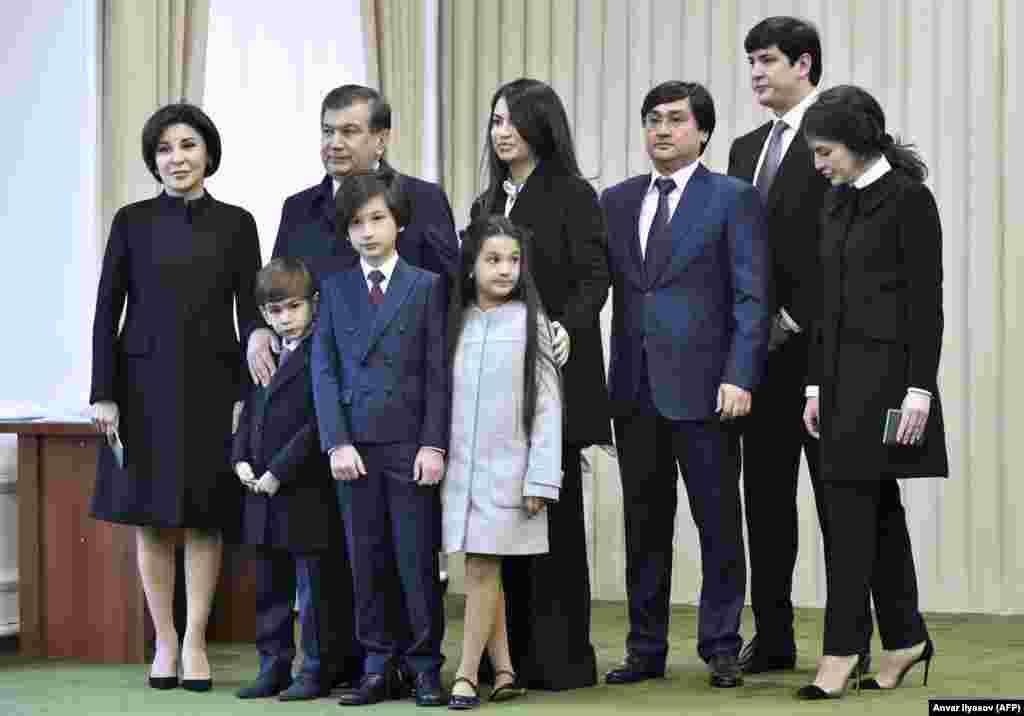 Uzbekistan -- Uzbek acting president, Shavkat Mirziyaev (3rdL), pose for photographers with his family at a polling station after voting for the presidential elections in Tashkent, December 4, 2016