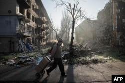 A resident walks past destroyed residential buildings in the frontline town of Kostyantynivka, Donetsk region, on November 15.