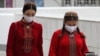 Women wearing protective face masks walk along the street in the Turkmen capital, Ashgabat. (file photo)