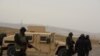 Soldiers man a checkpoint outside the village of Shetpe in December.
