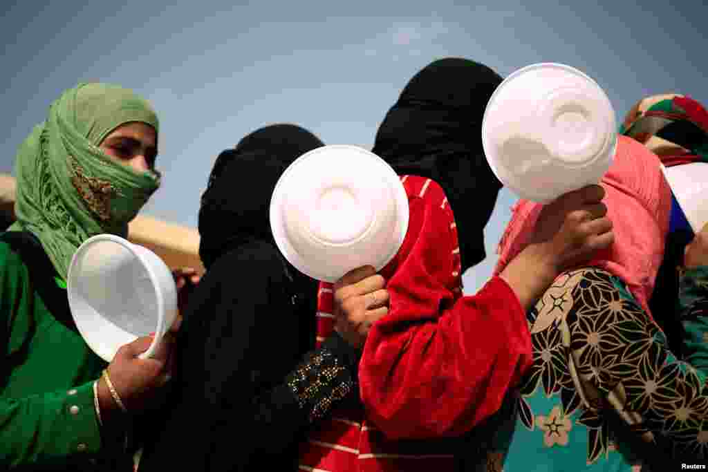 Women who recently fled the Islamic State stronghold of Hawija queue to receive food from the Barzani Charity Foundation on the outskirts of Irbil, Iraq. (Reuters/Zohra Bensemra)