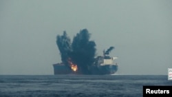 A 2024 photo shows an oil tanker in flames after being hit by a suspected Houthi missile in the Red Sea.