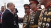 Russian President Vladimir Putin greets North Korean soldiers on Red Square after the Victory Day military parade in central Moscow on May 9, 2025.