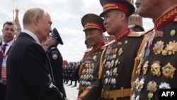 Russian President Vladimir Putin greets North Korean soldiers on Red Square after the Victory Day military parade in central Moscow on May 9, 2025.