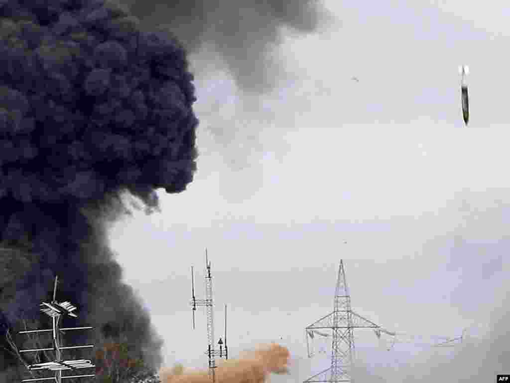 A missile drops on the tightly guarded residence of leader Muammar Qaddafi and military targets in the suburb of Tajura of the Libyan capital, Tripoli, on March 29. NATO-led coalition aircraft had been seen in the skies over the capital earlier in the afternoon . Photo by Mahmud Turkia for AFP