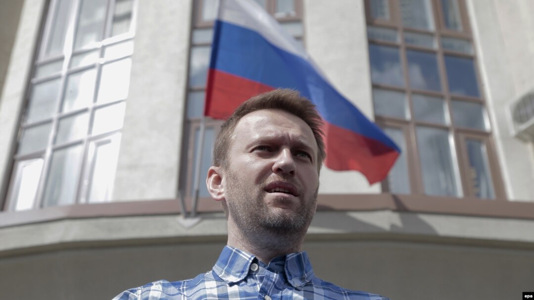 Anticorruption blogger and opposition leader Aleksei Navalny speaks to journalists in front of the Lyublinsky district court in Moscow on April 23.
