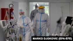 Intensive-care medical workers attend to patients at a hospital in Belgrade.