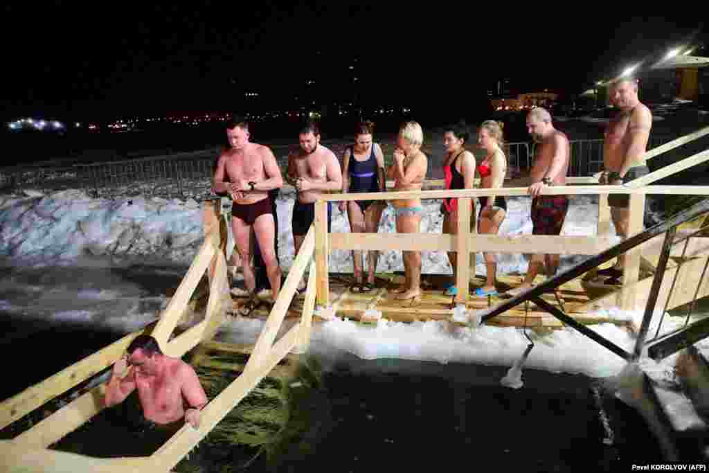 Believers in the Far Eastern Russian city of Vladivostok plunge into the icy waters of the Amur Bay on the Sea of Japan.