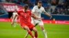 Russia's Aleksandr Sobolev (left) and Iraq's Ali Adnan challenge for the ball during the international friendly soccer match in St.Petersburg, Russia, on March 26.