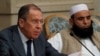 Russian Foreign Minister Sergei Lavrov (left) and Taliban delegate Alhaj Mohammad Sohail Shaina take part in multilateral peace talks on Afghanistan in Moscow in November 2018. 