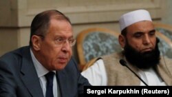 Russian Foreign Minister Sergei Lavrov and member of Taliban delegation Alhaj Mohammad Sohail Shaina take part in the multilateral peace talks on Afghanistan in Moscow, November 9