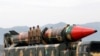 FILE: Pakistani soldiers stand beside a Shaheen III surface-to-surface ballistic missile during a military parade in Islamabad in March 2019.