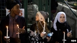 Mourners hold candles for victims of the mass shooting in San Bernardino, California.