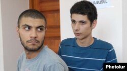 Opposition activists Davit Kiramijian (left) and Sargis Gevorgian at the start of their trial in Yerevan on July 14