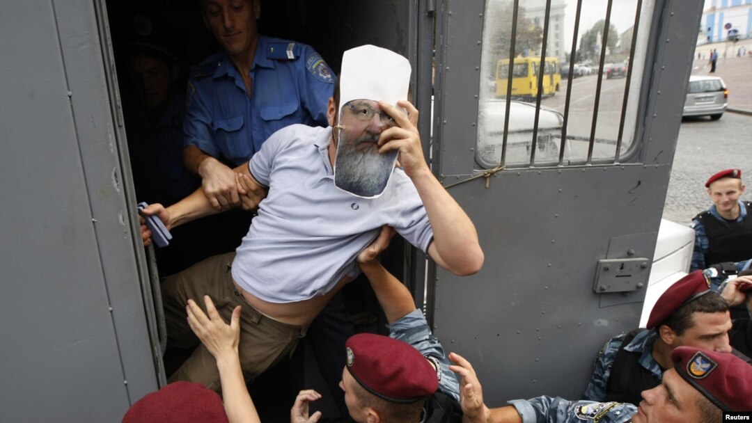 Policemen detaining a member of the Ukrainian nationalist party Svoboda (Freedom) as he intends to take part in a rally to protest against the visit of Russian Patriarch Kirill in Kyiv on July 26.