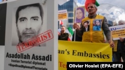 Iranian opposition activists protest with a poster depicting Iranian official Asadollah Assadi in Brussels in October 2018.