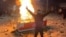 A protester makes a victory sign next to a fire in the midst of unrest in Abdanan, Iran, on January 6.