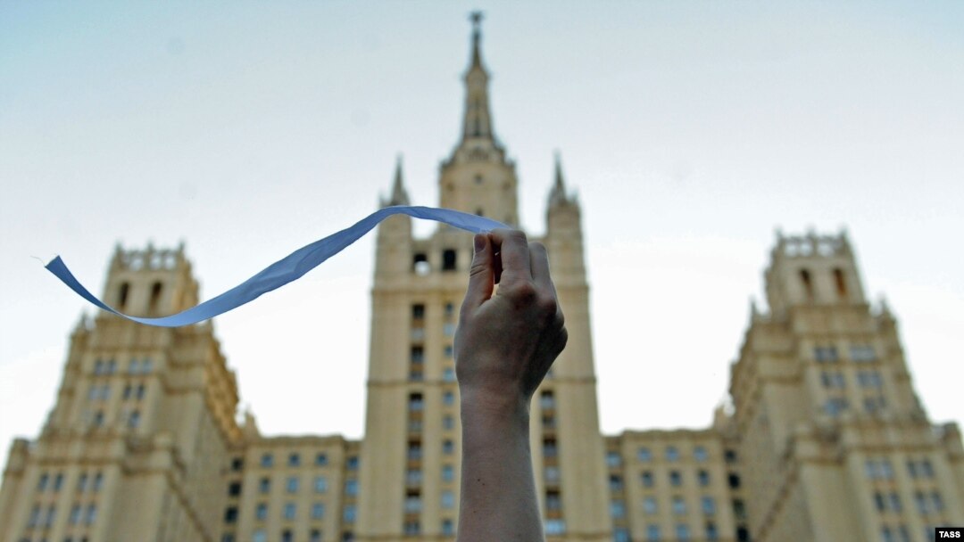 An opposition activist waves a white ribbon on Kudrinskaya Square in central Moscow.