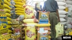 Iran - Iranian worker carry sacks of rice in at a rice depot . UNDATED