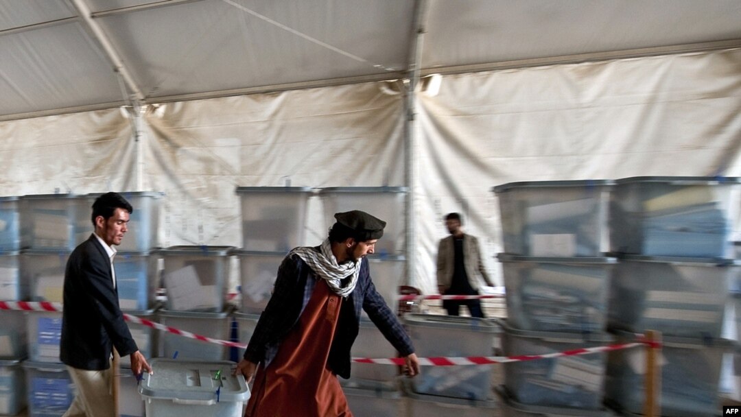 Afghan election workers move ballot boxes to the Independent Election Commission (IEC) warehouse in Kabul on September 19 in preparation for counting.