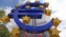 A giant logo of the euro currency stands in front of the European Central Bank in the banking district of Frankfurt, Germany.