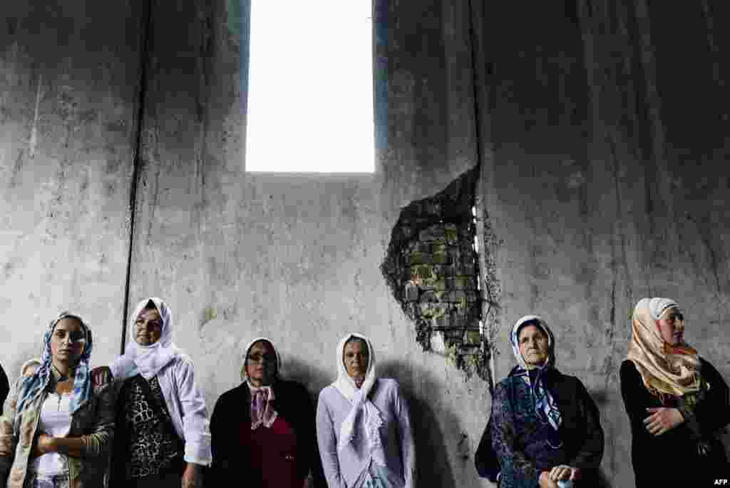 Bosnian women look at 136 coffins of newly identified victims of the 1995 Srebrenica massacre on July 9. (AFP/Dimitar Dilkoff)