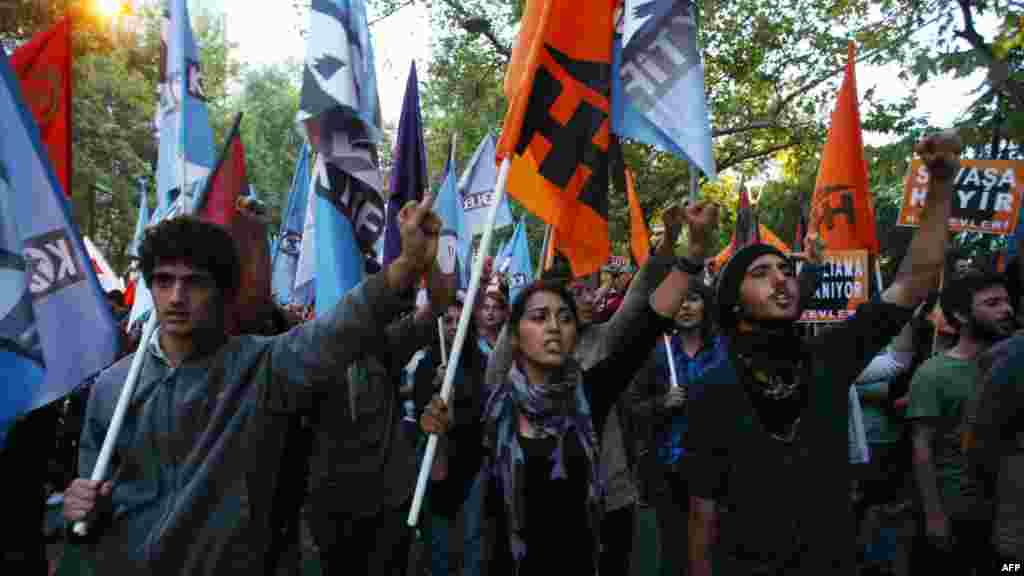 OCTOBER 4, 2012 -- Demonstrators hold flags and banners reading &quot;No to War&quot; as they take part in a protest outside the Turkish parliament in Ankara against military action against Syria. (AFP/Adem Altan) 