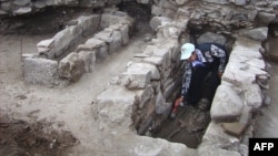 An archaeologist cleans a skeleton during excavations in the Black Sea town of Sozopol.