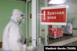 A health-care worker enters the red zone at a Moscow hospital for COVID patients.