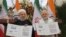 Indian Prime Minister Narendra Modi, right, with Iranian President Hassan Rouhani release a postal stamp commemorating growing economic and trade ties between the two nations in New Delhi, February 17, 2018