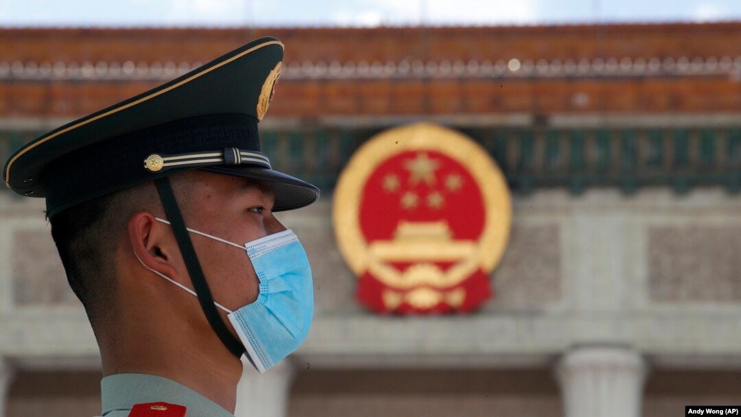 Policajac koji nosi masku prije završnog zasjedanja Kineske narodne političke konsultativne konferencije (CPPCC) u Velikoj dvorani naroda u Pekingu, srijeda, 27. maj 2020. 