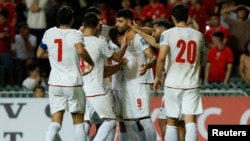 Iran's soccer team celebrates a goal in June 2024.