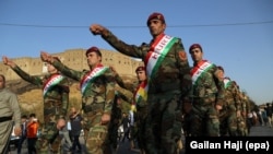 Kurdish Peshmerga fighters in traditional uniforms take part in a march to support the independence referendum in Irbil on September 13.