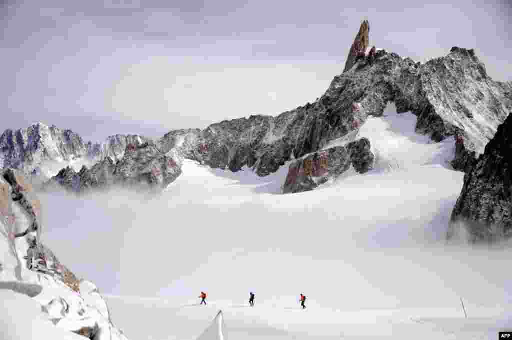 Trei alpiniști la 3400 m altitudine pe masivul Mont Blanc.